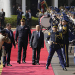 
              Lebanese President Michel Aoun, center right, inspects the honor guards before delivers a speech to his supporters gathered outside the presidential palace in Baabda, east of Beirut, Lebanon, Sunday, Oct. 30, 2022.   Aoun left Lebanon's presidential palace Sunday marking the end of his six-year term without a replacement, leaving the small nation in a political vacuum that is likely to worsen its historic economic meltdown. (AP Photo/Bilal Hussein)
            