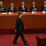 
              Chinese President Xi Jinping walks to the podium to give a speech at the opening ceremony of the 20th National Congress of China's ruling Communist Party held at the Great Hall of the People in Beijing, China, Sunday, Oct. 16, 2022. China on Sunday opens a twice-a-decade party conference at which leader Xi Jinping is expected to receive a third five-year term that breaks with recent precedent and establishes himself as arguably the most powerful Chinese politician since Mao Zedong. (AP Photo/Mark Schiefelbein)
            