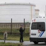 
              Riot police officer secure an access to the TotalEnergies oil depot, Thursday, Oct.13, 2022 outside Dunkirk, northern France. French President Emmanuel Macron promised the situation in the country's gas stations will soon be back to "normal" as the government started requisitioning some workers at ExxonMobil's Esso gas stations amid an ongoing strike that is making life difficult for French drivers. The government is considering making a similar decision soon regarding Total facilities, depending on the outcome of salary negotiations . (AP Photo/Michel Spingler)
            