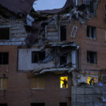 
              People check the damage at their apartments hit by a Russian missile in Mykolaiv, Sunday, Oct. 23, 2022. (AP Photo/Emilio Morenatti)
            