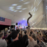 
              A man holds up a shofar as the audience prays inside a tent during the ReAwaken America Tour at Cornerstone Church in Batavia, N.Y., Friday, Aug. 12, 2022. The instrument, used in some Jewish worship services, has been adopted by the far right, and several people blew the horns to open the conference. (AP Photo/Carolyn Kaster)
            