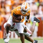 
              Tennessee running back Jabari Small (2) tries to escape from an Alabama defender during the first half of an NCAA college football game Saturday, Oct. 15, 2022, in Knoxville, Tenn. (AP Photo/Wade Payne)
            
