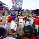 
              The Philadelphia Phillies celebrate a win over the Atlanta Braves after Game 4 of baseball's National League Division Series, Saturday, Oct. 15, 2022, in Philadelphia. The Philadelphia Phillies won, 8-3. (AP Photo/Matt Slocum)
            
