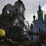 
              Destroyed domes lie next to a damaged church in the retaken village of Bohorodychne, eastern Ukraine, Saturday, Oct. 22, 2022. (AP Photo/Andriy Andriyenko)
            