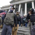 
              FILE - Members of the Oath Keepers on the East Front of the U.S. Capitol on Jan. 6, 2021, in Washington. A member of the Oath Keepers who traveled to Washington before the Jan. 6 attack at the U.S. Capitol testified during the seditious conspiracy case against Oath Keepers founder Stewart Rhodes and four associates on Wednesday, Oct. 12, 2022, about a massive cache of weapons the far-right extremist group stashed in a Virginia hotel room. (AP Photo/Manuel Balce Ceneta)
            