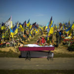 
              The body of recently killed Ukrainian serviceman Vadim Bereghnuy, 22, rests in a coffin during his funeral in a cemetery in Kharkiv, Ukraine, Monday, Oct. 17, 2022. (AP Photo/Francisco Seco)
            