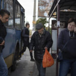 
              An elderly man prepares to get on a bus in Kramatorsk, Ukraine, Friday, Oct. 7, 2022. (AP Photo/Leo Correa)
            