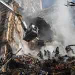 
              FILE -  Firefighters work after a drone attack on buildings in Kyiv, Ukraine, on Oct. 17, 2022. Russia has declared its intention to increase its targeting of Ukraine’s power, water and other vital infrastructure in its latest phase of the nearly 8-month-old war. (AP Photo/Roman Hrytsyna, File)
            