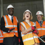 
              Britain's Prime Minister Liz Truss, centre right and Chancellor of the Exchequer Kwasi Kwarteng react during a visit to a construction site for a medical innovation campus, on day three of the Conservative Party annual conference at the International Convention Centre in Birmingham, England, Tuesday, Oct. 4, 2022. (Stefan Rousseau/Pool Photo via AP)
            