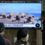 
              A TV screen shows a file image of North Korea's military exercise during a news program at the Seoul Railway Station in Seoul, South Korea, Friday, Oct. 14, 2022. South Korea's military says it detected North Korea additionally firing possibly hundreds of artillery rounds into maritime buffer zones between the rivals, further raising animosities triggered by a recent barrage of weapons tests. (AP Photo/Ahn Young-joon)
            