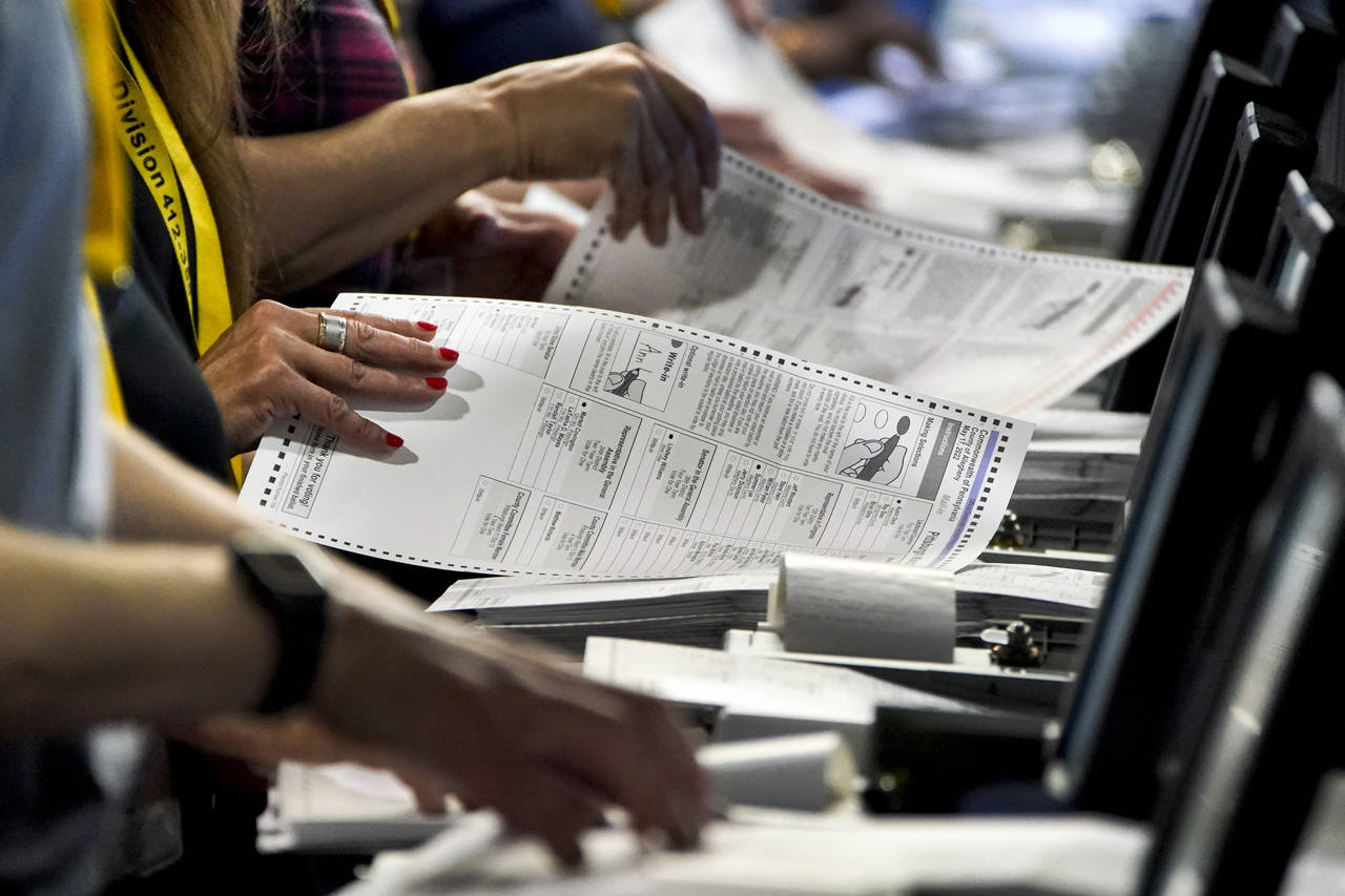 FILE - Election workers perform a recount of ballots from the recent Pennsylvania primary election ...