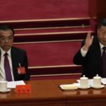 
              Chinese President Xi Jinping looks over as Chinese Premier Li Keqiang raises his hand to vote at the closing ceremony of the 20th National Congress of China's ruling Communist Party at the Great Hall of the People in Beijing, Saturday, Oct. 22, 2022. Chinese Premier Li Keqiang, the nation's No. 2 official and a chief proponent of economic reforms, is among four of the seven members of the nation's all-powerful Politburo Standing Committee who will not be reappointed in a leadership shuffle Sunday. (AP Photo/Ng Han Guan)
            