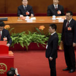 
              FILE - Incoming Chinese President Xi Jinping, left, casts his vote into a box as Vice Premier Li Keqiang, right, looks on during a plenary session of the National People's Congress held at the Great Hall of the People in Beijing on March 14, 2013. Chinese President Xi Jinping was the son of a communist revolutionary leader, a victim of the Cultural Revolution and a provincial leader who promoted economic growth before ascending to the very top a decade ago. (AP Photo/Andy Wong, File)
            