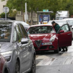 
              A man pushes his car to reach a gas station, Friday, Oct. 14, 2022 in Nanterre, outside Paris. Strikes in the French refineries of TotalEnergies group were still going on Friday, heavily disrupting fuel supplies as hard-left CGT union rejected a deal over pay rise that has been found between the energy giant and two other more moderate unions. (AP Photo/Michel Euler)
            