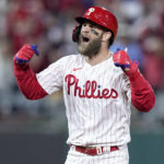 
              Philadelphia Phillies' Bryce Harper celebrates after his RBI double during the fifth inning in Game 4 of the baseball NL Championship Series between the San Diego Padres and the Phillies on Saturday, Oct. 22, 2022, in Philadelphia. (AP Photo/Matt Rourke)
            