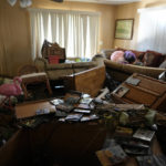 
              Furniture and personal items lie jumbled in the living room of Nita Ross, 79, as she returns to her mobile home for the first time since the passage of Hurricane Ian, at the Sunshine Mobile Home Park in Fort Myers, Fla., Saturday, Oct. 1, 2022. Ross' home stayed on its foundations, unlike those of some of her neighbors, but storm flooding almost to the height of the ceiling destroyed most of her possessions and household items. (AP Photo/Rebecca Blackwell)
            