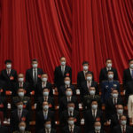 
              Delegates wear masks as they attend the opening ceremony of the 20th National Congress of China's ruling Communist Party held at the Great Hall of the People in Beijing, China, Sunday, Oct. 16, 2022. China on Sunday opens a twice-a-decade party conference at which leader Xi Jinping is expected to receive a third five-year term that breaks with recent precedent and establishes himself as arguably the most powerful Chinese politician since Mao Zedong. (AP Photo/Mark Schiefelbein)
            