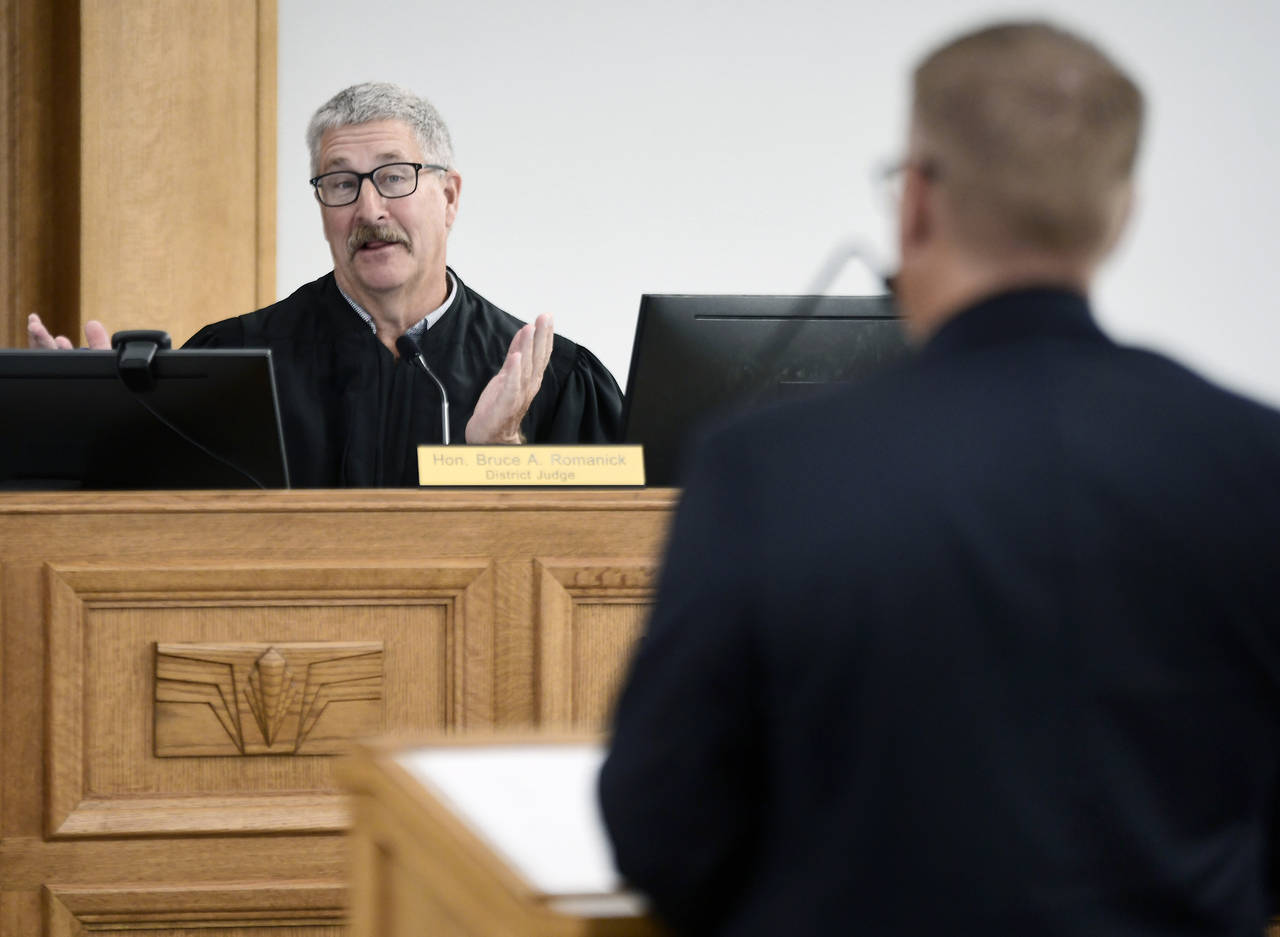 FILE - South Central District Judge Bruce Romanick, left, asks a question during a preliminary inju...