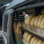 
              A driver loads the last of his rolls before leaving the a bakery to deliver near the front line in Kostiantynivka, Donetsk region, eastern Ukraine, Saturday, Aug. 20, 2022. The bakery has 20 drivers deliver bread daily, not only to cities, but also to half-empty front-line villages. (AP Photo/David Goldman)
            