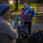
              Locals gather to receive food given by Ukrainian volunteers in the recently retaken village of Borova village, east Ukraine, Friday, Oct. 7, 2022. (AP Photo/Francisco Seco)
            
