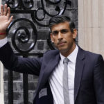 
              New British Prime Minister Rishi Sunak waves after arriving at Downing Street in London, Tuesday, Oct. 25, 2022, after returning from Buckingham Palace where he was formally appointed to the post by Britain's King Charles III. (AP Photo/Alberto Pezzali)
            