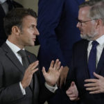 
              France's President Emmanuel Macron, left, speaks with Czech Republic's Prime Minister Petr Fiala at a group photo during a meeting of the European Political Community at Prague Castle in Prague, Czech Republic, Thursday, Oct 6, 2022. Leaders from around 44 countries are gathering Thursday to launch a "European Political Community" aimed at boosting security and economic prosperity across the continent, with Russia the one major European power not invited. (AP Photo/Alastair Grant, Pool)
            