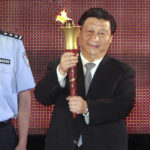 
              FILE - Xi Jinping, then Shanghai's Communist Party chief holds the torch for the Special Olympic Games to be held in Shanghai, China, on Sept. 29, 2007. Chinese President Xi Jinping was the son of a communist revolutionary leader, a victim of the Cultural Revolution and a provincial leader who promoted economic growth before ascending to the very top a decade ago. (AP Photo, File)
            
