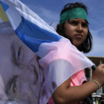 
              A girl carries a flag with an image of Brazil's President Jair Bolsonaro, who is running for reelection, during a campaign event in Brasilia, Brazil, Saturday, Oct. 29, 2022.  Bolsonaro is facing former President Luiz Inacio Lula da Silva in a runoff election set for Oct. 30. (AP Photo/Eraldo Peres)
            