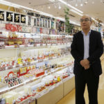 
              Akky International Corp. Chief Executive Hideyuki Abe looks around his store in the Akihbara electronics district of Tokyo on Oct. 3, 2022. Individual travelers will be able to visit Japan without visas beginning Tuesday, Oct. 11, just like in pre-COVID-19 times. (AP Photo/Yuri Kageyama)
            