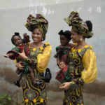 
              Twins Oladapo Taiwo, left, and Oladapo Kehinde, 21, pose for photographs holding relative's twins during the Annual twin festival in Igbo-Ora South west Nigeria, Saturday, Oct. 8, 2022. The town holds the annual festival to celebrate the high number of twins and multiple births. (AP Photo/Sunday Alamba)
            