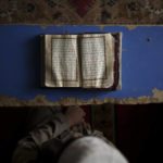 
              FILE - A student reads the Quran at a madrassa in Kabul, Afghanistan, Tuesday, Sept. 28, 2021. The American concept of adoption doesn’t exist in Afghanistan. Under Islamic law, a child’s bloodline cannot be severed and their heritage is sacred. Instead of adoption, a guardianship system called kafala allows Muslims to take in orphans and raise them as family, without relinquishing the child’s name or bloodline. (AP Photo/Felipe Dana, File)
            