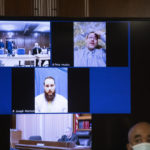 
              Pete Musico, top right, and Joseph Morrison, center, are seen in a video display as they react to a guilty verdict as it is read in the courtroom on Wednesday, Oct. 26, 2022, at the Jackson County Courthouse in Jackson, Mich. Paul Bellar, Joseph Morrison and Pete Musico are accused of being involved in a plot to kidnap Michigan Gov. Gretchen Whitmer. The three were found guilty of one felony count each of gang membership, providing material support for terrorist acts and felony firearms. (J. Scott Park/Jackson Citizen Patriot via AP, Pool)
            
