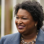 
              FILE - Georgia Democratic gubernatorial candidate Stacey Abrams talks to the media during Georgia's primary election on Tuesday, May 24, 2022, in Atlanta. The Georgia governor's race is a rematch of 2018, when Brian Kemp narrowly defeated Stacey Abrams. (AP Photo/Brynn Anderson, File)
            