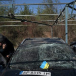 
              Dmytro Pocishchuk checks his car, which was damaged after a Russian attack in Zaporizhzhia, Ukraine, Saturday, Oct. 15, 2022. (AP Photo/Leo Correa)
            