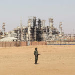 
              FILE - An Algerian soldier stands guard during a visit for news media, organized by the Algerian authorities, at the gas plant in Ain Amenas, seen in background, Friday, Jan. 31, 2013. While Africa's natural gas reserves are vast and North African countries like Algeria have pipelines already linked to Europe, a lack of infrastructure and security challenges have long stymied producers in other parts of the continent from scaling up exports.(AP Photo, File)
            