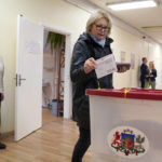 
              A woman casts her ballot at a polling station during general elections in Riga, Latvia, Saturday, Oct. 1, 2022. Polling stations opened Saturday in Latvia for a general election influenced by neighboring Russia’s attack on Ukraine, disintegration among the Baltic country’s sizable ethnic-Russian minority and the economy, particularly high energy prices. (AP Photo/Roman Koksarov)
            