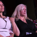 
              Cinnamon King, left, Jenn Closi and Nevada first lady Kathy Sisolak listen to a debate between Gov. Steve Sisolak, D-Nev., and Nevada Republican gubernatorial nominee Joe Lombardo during IndyFest at Worre Studios, Sunday, Oct. 2, 2022, in Las Vegas. King and Closi's husbands, both Las Vegas Metropolitan Police Department officers who died of COVID-19, were acknowledged during the debate. (AP Photo/Ellen Schmidt)
            