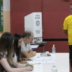 
              Brazilian President Jair Bolsonaro, who is running for another term, looks at electoral officials before voting in the general election in Rio de Janeiro, Brazil, Sunday, Oct. 2, 2022. (Andre Coelho/Pool via AP))
            