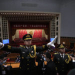 
              A director conducts band members as they perform during the closing ceremony of the 20th National Congress of China's ruling Communist Party at the Great Hall of the People in Beijing, Saturday, Oct. 22, 2022. (AP Photo/Ng Han Guan)
            