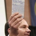 
              Utah Republican Sen. Mike Lee waves his pocket Constitution during a campaign event with former U.S. Rep. Tulsi Gabbard, who left the Democratic Party earlier this month Thursday, Oct. 27, 2022, in Draper, Utah. Lee is locked in a competitive race against independent Evan McMullin, who throughout the campaign has spotlighted his relationship with former President Donald Trump and communications with his staff in the lead-up to the Jan. 6 attack on the U.S. Capitol. (AP Photo/Rick Bowmer)
            