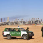 
              FILE - Algerian soldiers stand guard during a visit for news media, organized by the Algerian authorities, at the gas plant in Ain Amenas, seen in background, Friday, Jan. 31, 2013. While Africa's natural gas reserves are vast and North African countries like Algeria have pipelines already linked to Europe, a lack of infrastructure and security challenges have long stymied producers in other parts of the continent from scaling up exports.(AP Photo, File)
            