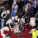 
              Rescue workers treat injured people on the street in Seoul, South Korea, Sunday, Oct. 30, 2022. People were killed and injured after being crushed by a large crowd pushing forward on a narrow street during Halloween festivities in the capital of Seoul, South Korean officials said. (AP Photo/Lee Jin-man)
            