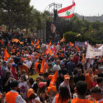 
              Supporters of Lebanese President Michel Aoun listen to his speech outside the presidential palace in Baabda, east of Beirut, Lebanon, Sunday, Oct. 30, 2022. Aoun left Lebanon's presidential palace Sunday marking the end of his six-year term without a replacement, leaving the small nation in a political vacuum that is likely to worsen its historic economic meltdown. (AP Photo/Bilal Hussein)
            