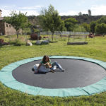 
              Suzy Elghanayan sits on a trampoline with Gretl, a pygmy goat, at the Selah Carefarm in Cornville, Ariz., Oct. 4, 2022. Her son, Luca, 20, died earlier in the year of a seizure. (AP Photo/Dario Lopez-Mills)
            