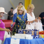 
              First lady Jill Biden and others, fill bags of supplies for Hurricane Fiona victims, Monday, Oct. 3, 2022, in Ponce, Puerto Rico, during a visit to Centro Sor Isolina Ferre Aguayo School. (AP Photo/Evan Vucci)
            