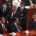 
              Chinese President Xi Jinping, right, looks on as former Chinese President Hu Jintao, standing at center, touches the shoulder of Premier Li Keqiang, center, as he is assisted to leave the hall during the closing ceremony of the 20th National Congress of China's ruling Communist Party at the Great Hall of the People in Beijing, Saturday, Oct. 22, 2022. (AP Photo/Andy Wong)
            