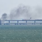 
              A helicopter flies to drop water to stop fire on Crimean Bridge connecting Russian mainland and Crimean peninsula over the Kerch Strait, in Kerch, Crimea, Saturday, Oct. 8, 2022. Russian authorities say a truck bomb has caused a fire and the collapse of a section of a bridge linking Russia-annexed Crimea with Russia. The bridge is a key supply artery for Moscow's faltering war effort in southern Ukraine. (AP Photo)
            