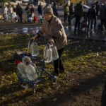
              Catherine, 75, pushes her walker loaded with plastic bottles after refilling them in a tank, in the center of Mykolaiv, Monday, Oct. 24, 2022. Since mid-April, citizens of Mykolaiv, with a pre-war population of half a million people, have lived without a centralized drinking water supply. Russian Forces cut off the pipeline through which the city received drinking water for the last 40 years. (AP Photo/Emilio Morenatti)
            