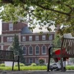 
              FILE - A young man reads on the Howard University campus July 6, 2021, in Washington. A recent poll found that Black Americans have a more positive outlook on upward mobility for future generations than white Americans. (AP Photo/Jacquelyn Martin, File)
            