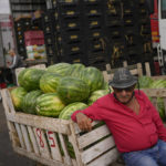 
              A worker rests after loading watermelons in a cart at the Cease wholesale market in Sao Paulo, Brazil, Tuesday, Oct. 25, 2022. Brazil's presidential run-off election is scheduled for Oct. 30. (AP Photo/Matias Delacroix)
            